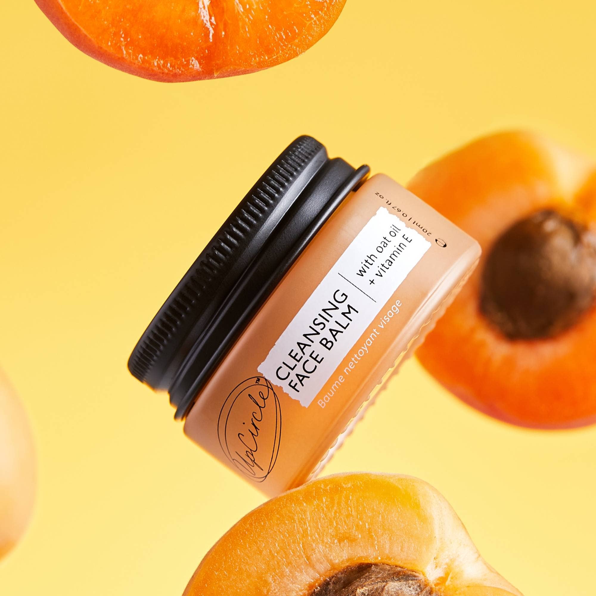 Cleansing face balm jar with apricot slices on a yellow background