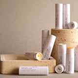Collection of VELY lip balms on a neutral background