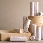 Collection of VELY lip balms on a neutral background