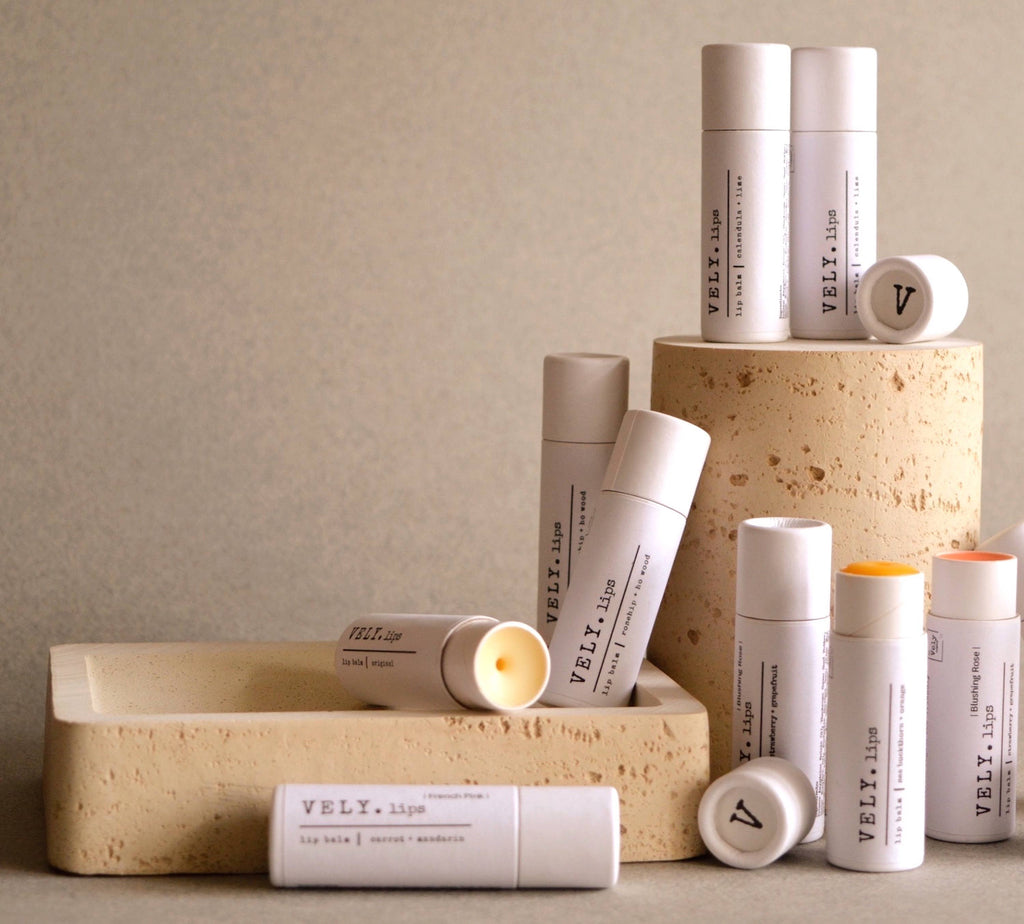 Collection of VELY lip balm products on a neutral background