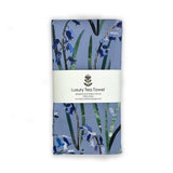 Folded handmade cotton tea towel with floral bluebell design on a white background
