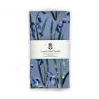 Folded handmade cotton tea towel with floral bluebell design on a white background