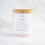 Bath salts container labeled 'Salt + Steam Beauty Sleep' on a white background