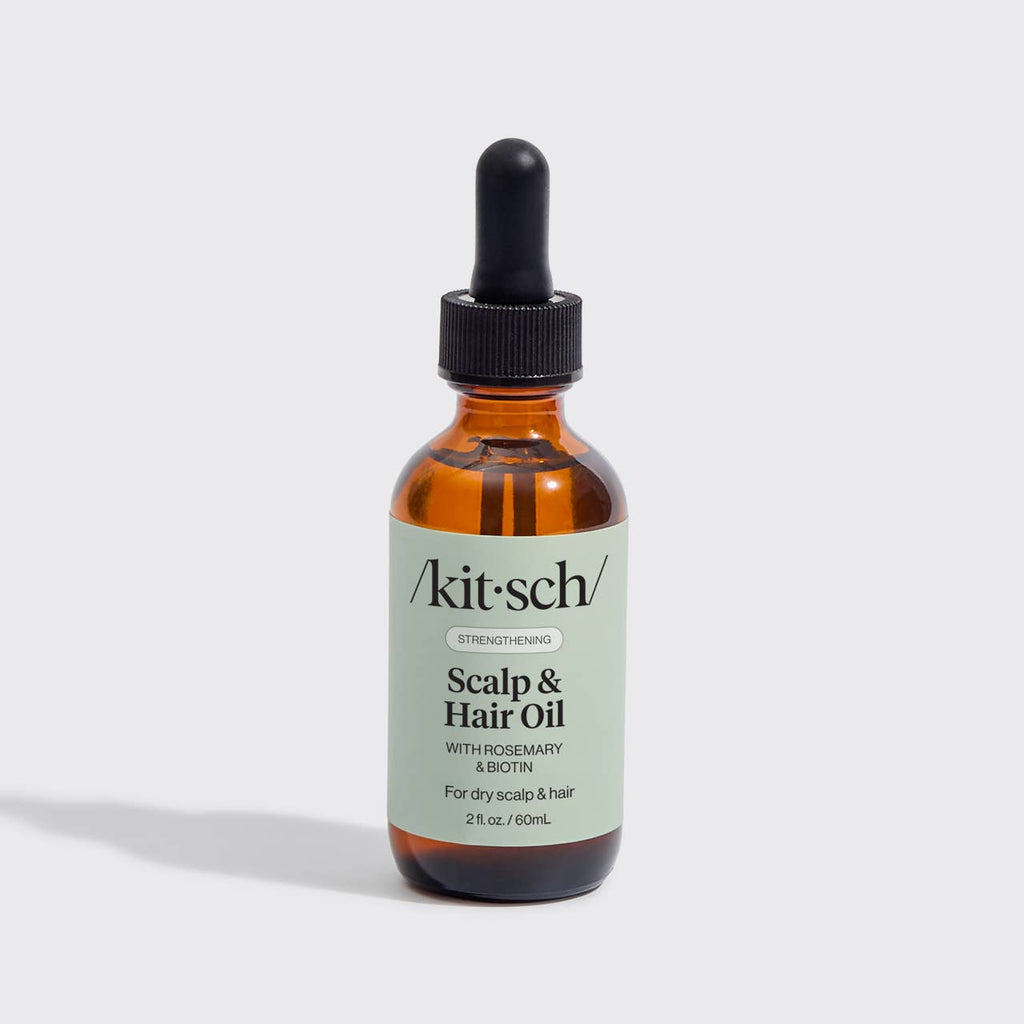 Kitsch scalp and hair oil bottle with dropper on a light grey background