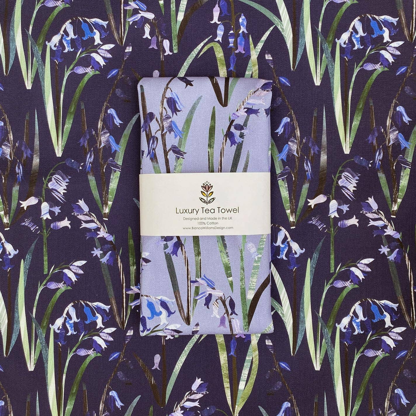 Packaged tea towel with floral bluebell design on a matching contrasting fabric background