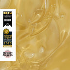 Gold liquid with beauty awards on a white background