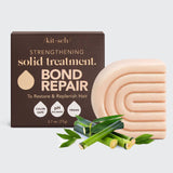 Kitsch Bond Repair solid treatment bar with packaging and bamboo leaves on a light gray background