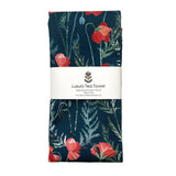 Folded tea towel with red floral poppy design and brand label on a white background
