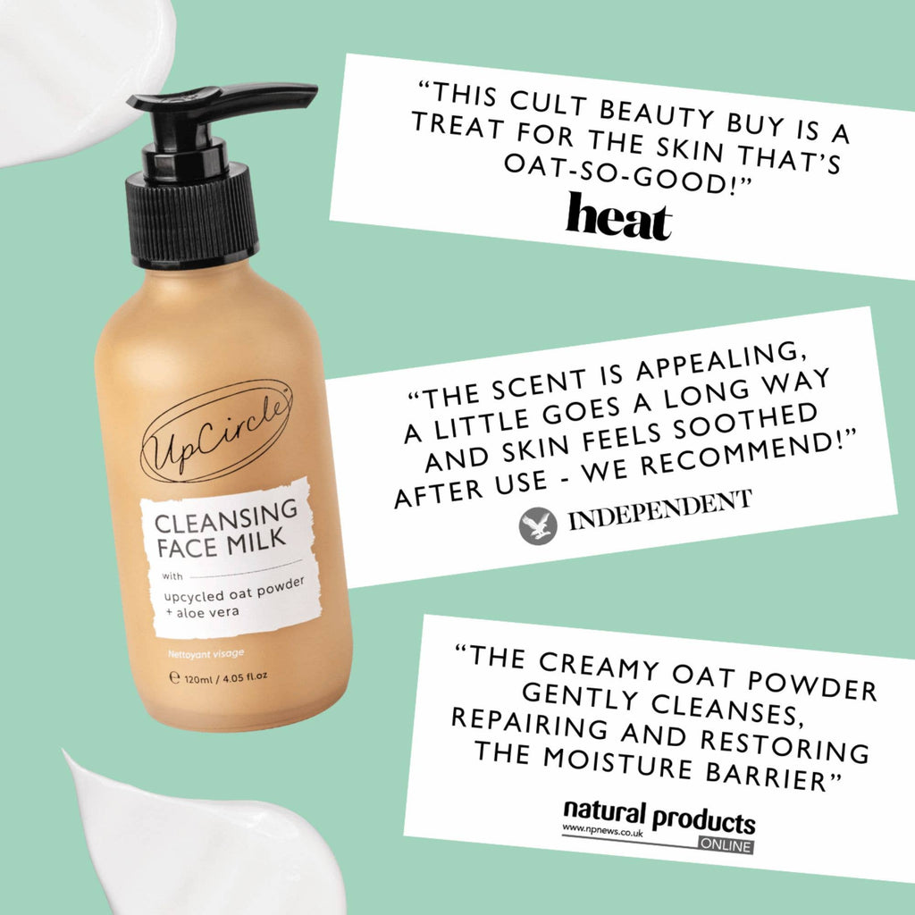 UpCircle Cleansing Face Milk bottle with pump dispenser, and positive reviews from Heat magazine, Independent newspaper and Natural Products Online, on a green background