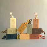 Set of VELY soap bars with rope handles on a neutral background