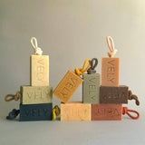 Set of VELY soap bars with rope handles on a neutral background