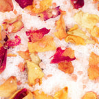 Bath salts with colourful red and orange flower petals 