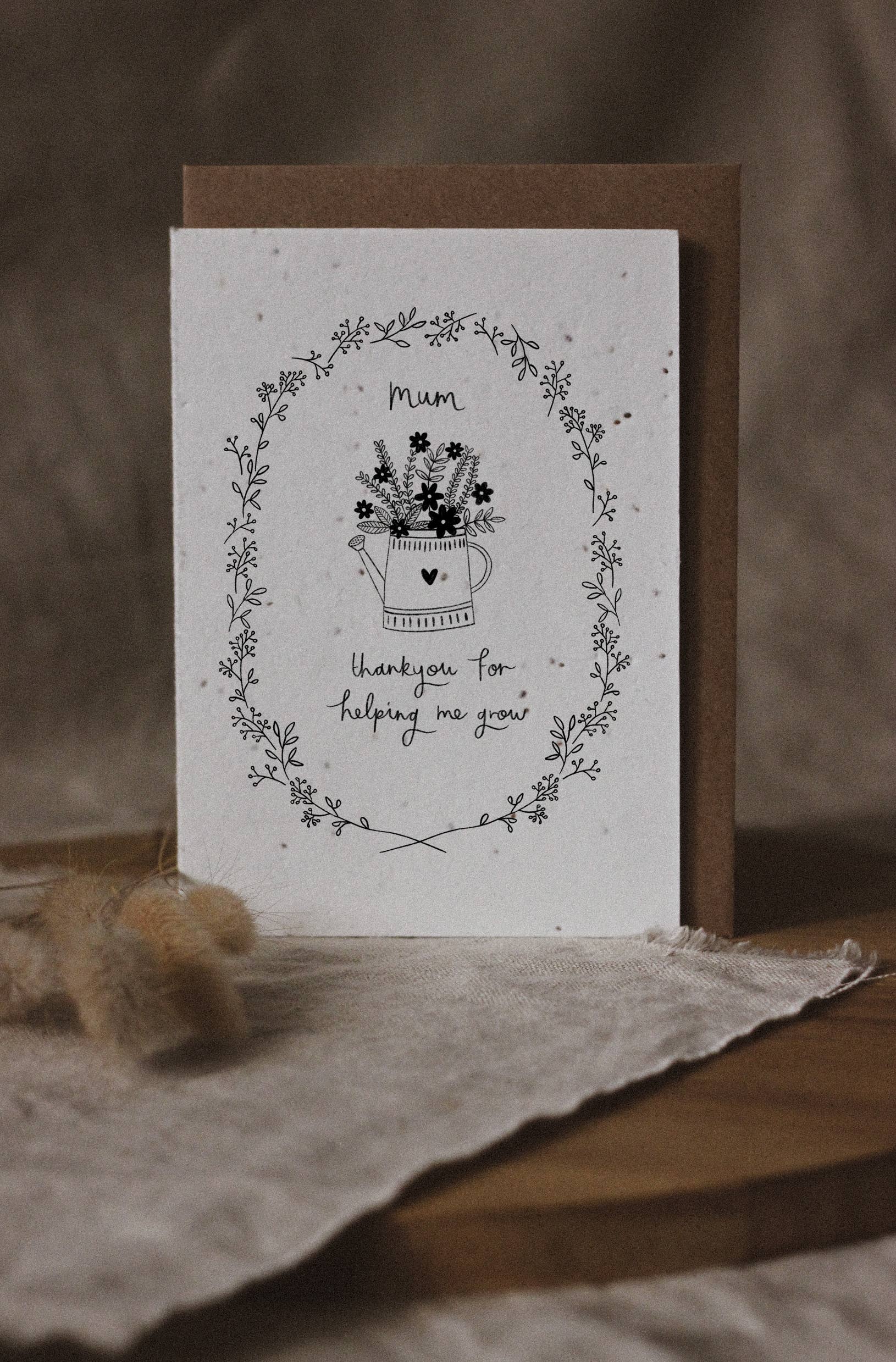 Greeting card with floral design and text on a wooden surface