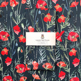 Tea towel with red poppy design and 'Luxury Tea Towel' label on a matching background