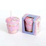 Pink tumbler with unicorn design and straw, displayed with its packaging on a white background.