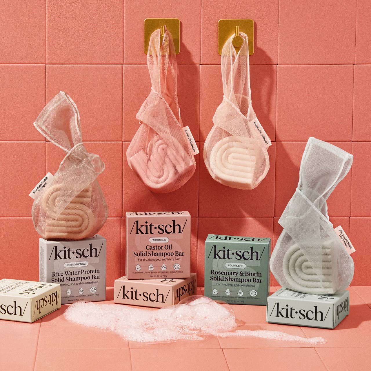 Selection of Kitsch solid shampoo bars and Kitsch solid conditioner bars in Kitsch bar saver bags, hanging on hooks with Kitsch haircare product packaging.