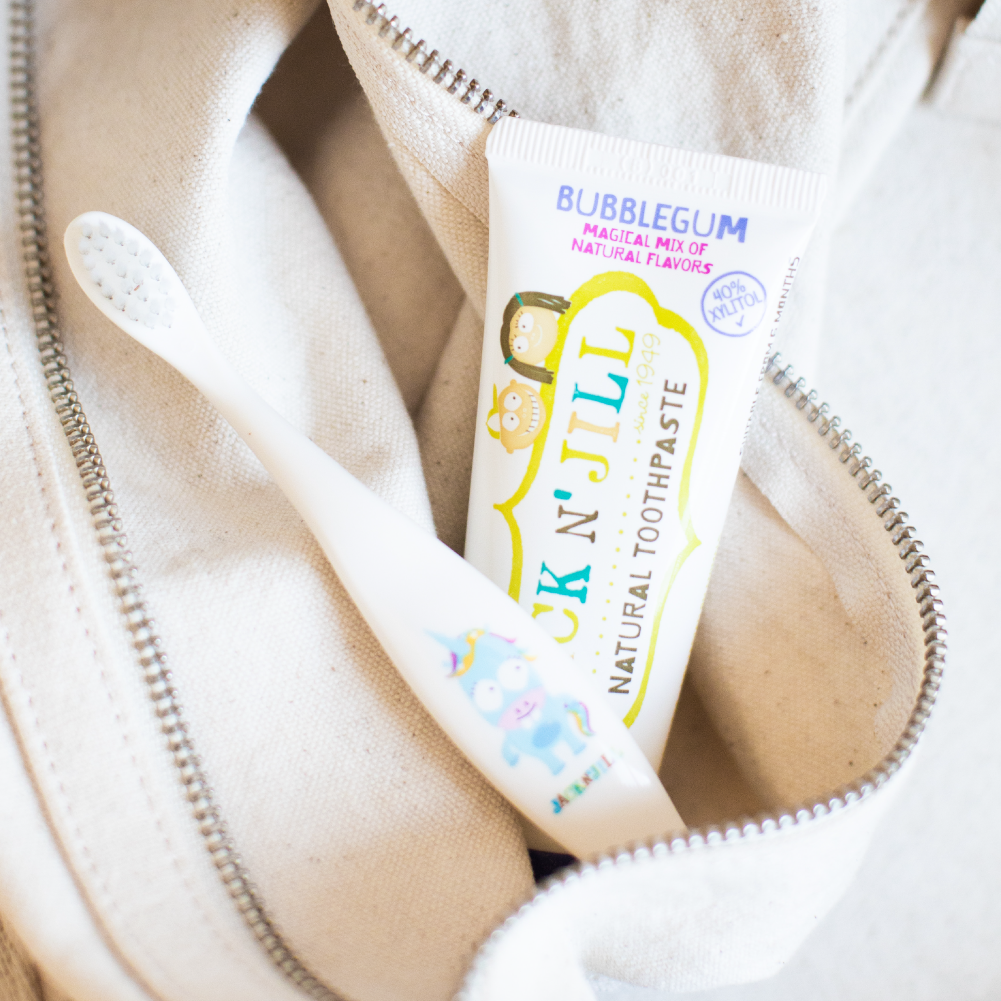 Tube of Jack N' Jill bubblegum-flavored toothpaste in a beige bag.