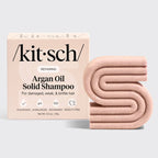 Kitsch argan oil solid shampoo bar and packaging on a light gray background